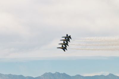 Low angle view of airshow against sky