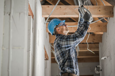 Side view of manual worker working at site