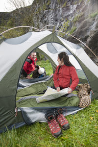 Couple packing up camp and getting ready to go hiking in the uk