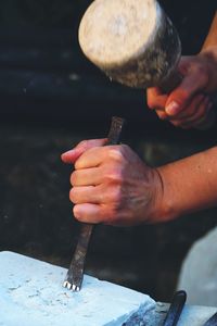 Midsection of man working on wood