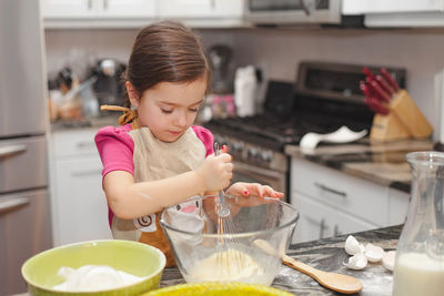 Cute girl having food at home