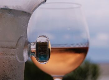 Cropped image of pitcher against wineglass