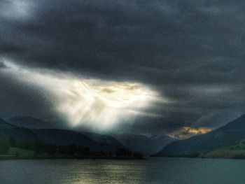 Scenic view of lake against cloudy sky