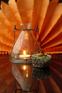 Close-up of illuminated candles on table