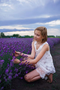 Girl crouching at lavender field