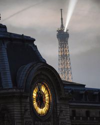 Low angle view of buildings against cloudy sky