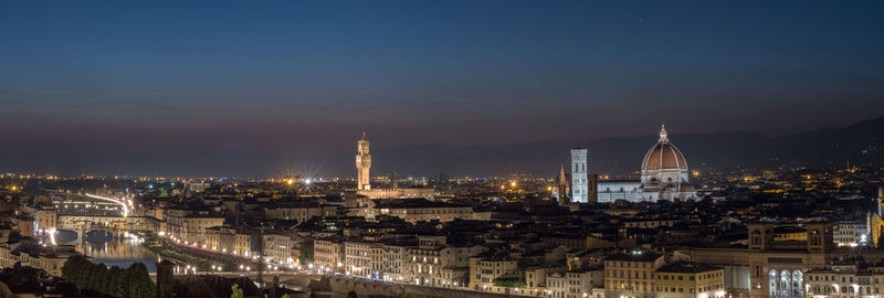 High angle view of city lit up at night