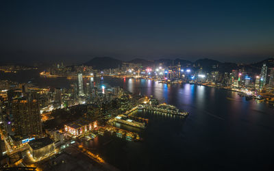 High angle view of illuminated cityscape against sky at night