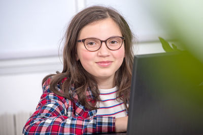 Portrait of young woman using mobile phone