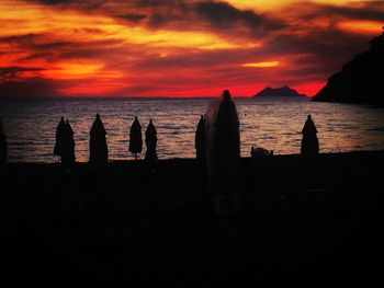 Silhouette of people on beach during sunset