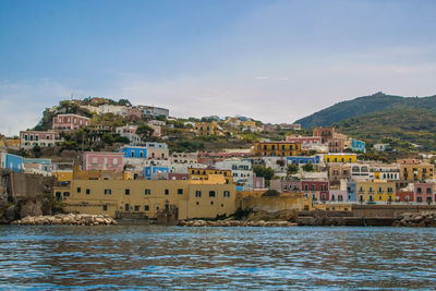 Town by sea against sky