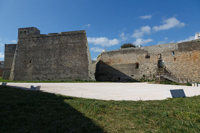 Buildings on field against sky