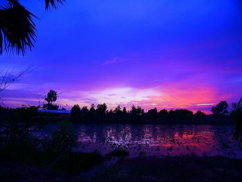 Scenic view of lake against sky at sunset