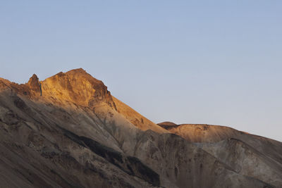 Low angle view of rock formations against clear sky