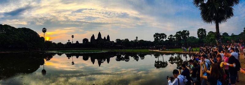 Crowd photographing by lake at angkor wat