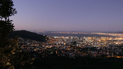 High angle view of illuminated townscape against sky at night