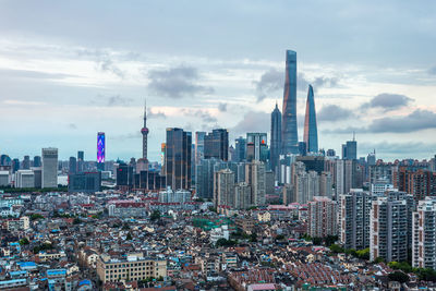 Aerial view of modern buildings in city against sky