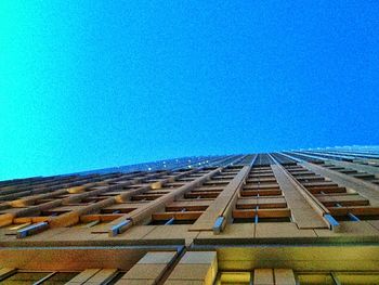 Low angle view of buildings against clear blue sky