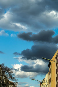 Low angle view of building against cloudy sky