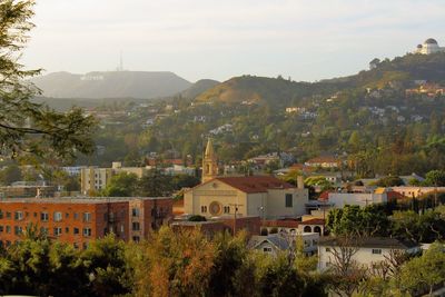 Buildings in town against sky