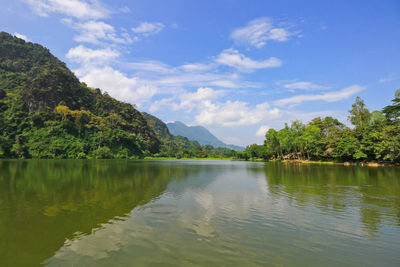 Idyllic shot of river and mountains against sky