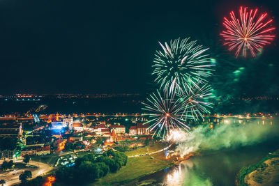 Firework display in city at night