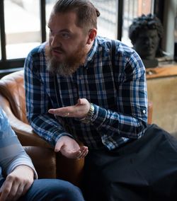 Man in suspender talking with woman at home