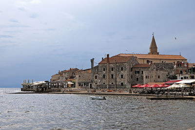 View of buildings against cloudy sky