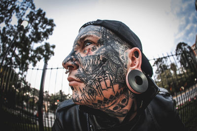 Portrait of man wearing mask against sky