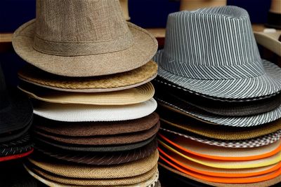 Stacked hats at market for sale