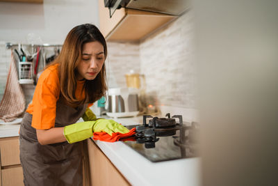 Portrait of young woman using mobile phone at home