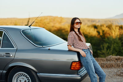 Rear view of woman sitting in car