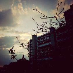 Low angle view of building against cloudy sky