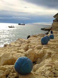 Scenic view of rocks on beach against sky