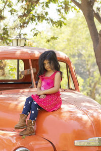 Portrait of girl sitting in car