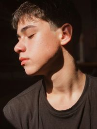 Close-up of young man with closed eyes at home
