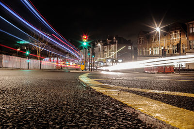 Illuminated light trails on city street at night