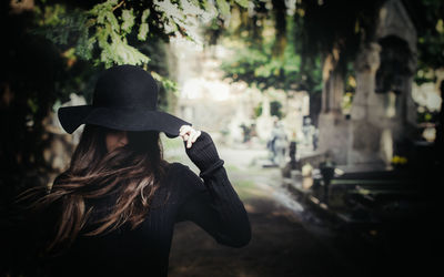 Woman wearing hat standing outdoors