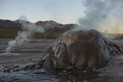 Smoke emitting from volcanic mountain against sky