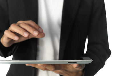 Midsection of man using mobile phone