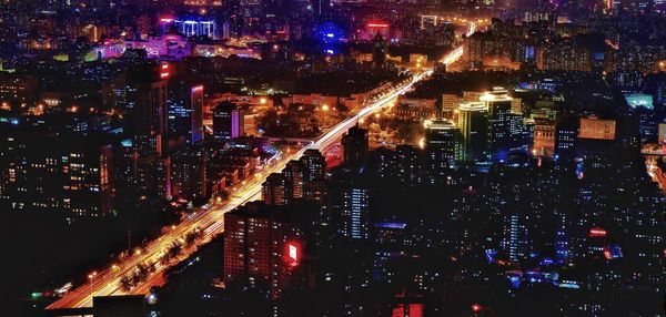 High angle view of illuminated buildings in city at night