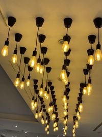 Low angle view of illuminated lights hanging from ceiling