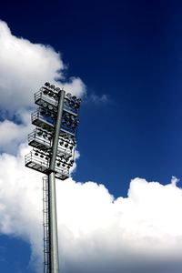 Low angle view of floodlight against blue sky