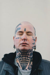 Portrait of young man against wall