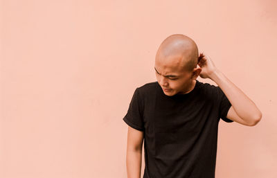 Side view of a young man against white background