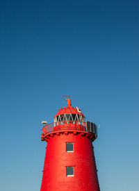 Low angle view of lighthouse against clear blue sky