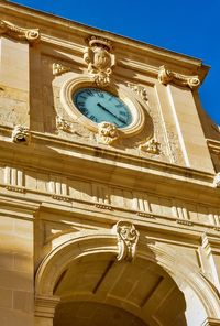 Low angle view of clock tower against sky