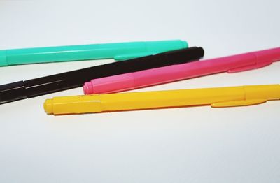 Close-up of colored pencils against white background