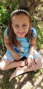 Portrait of a smiling girl sitting outdoors