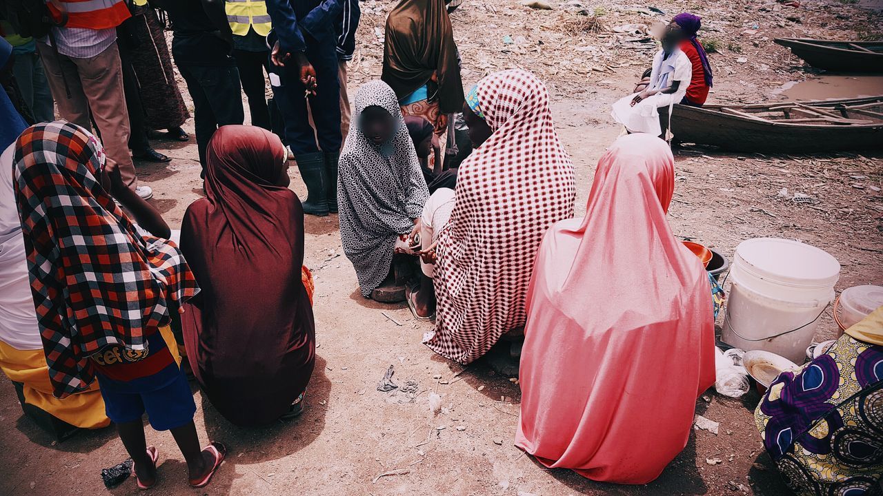 CLOSE-UP LOW SECTION OF PEOPLE ON ROAD